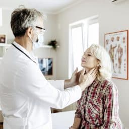 Shot of a mature male doctor examining a senior female patient in his medical office